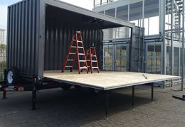 A fold-down container/stage mounted on a trailer