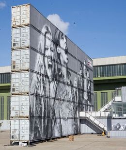 A wall made from stacking a line of Shipping Containers